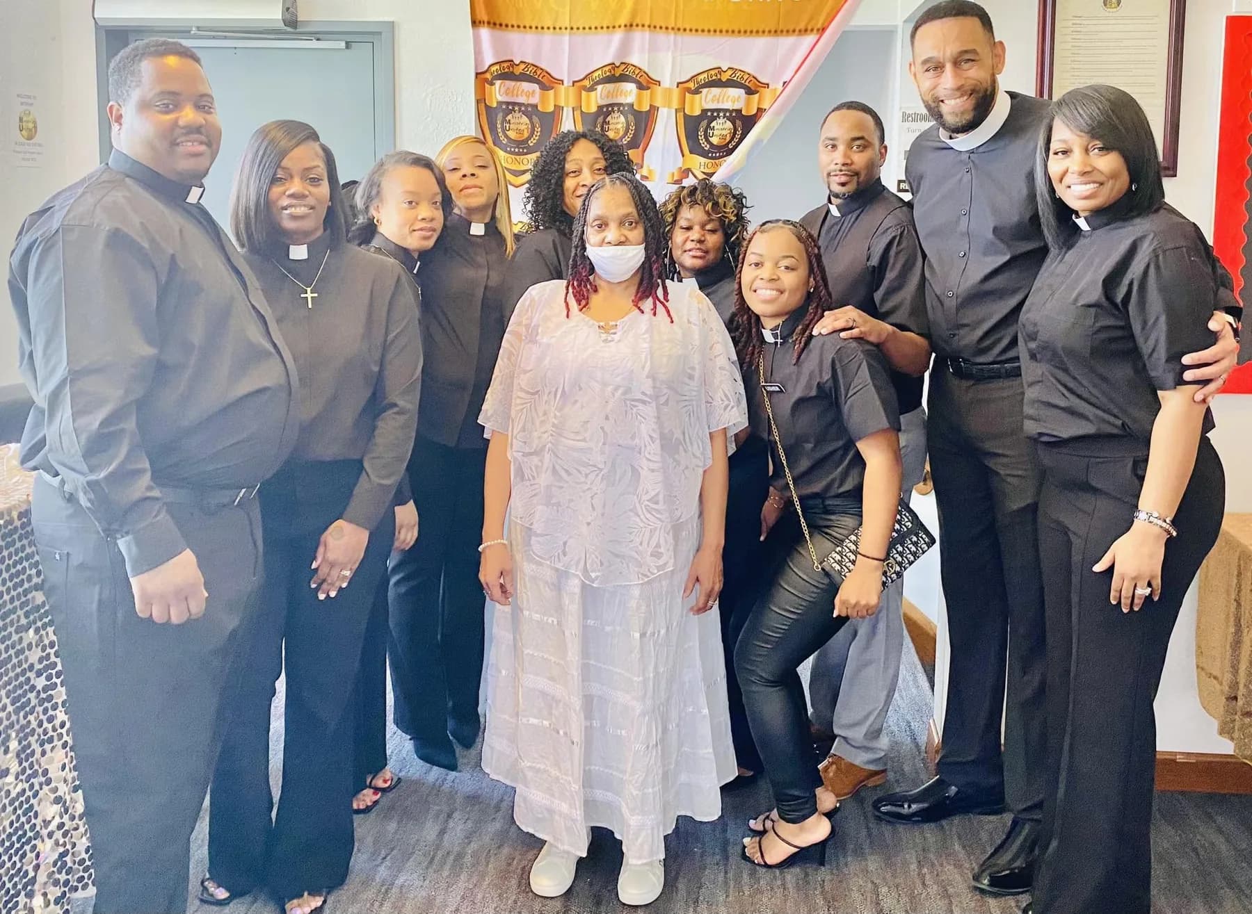 The leadership of Currie The Cross Church together, many in black clerical shirts and collars